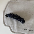 Close-up of floral fabric banana hair clip with deep blue pattern and sturdy plastic clasp - Navy Blue Yellow Floral