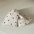 Close-up of cream knit hairband with embroidered black heart patterns and soft texture - White Triangle Black Heart Claw Clip