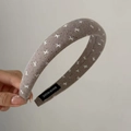 Detail view of brown sponge headband with white bow patterns and HAND MADE label - Milk Tea White Bow