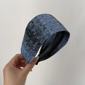 Close-up of a wide blue and black knitted headband showing rich textured yarn fabric detail - Light Blue