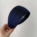Detail of dark blue knitted wide headband showing ribbed texture and thick elastic fabric - Blue