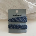 Dettaglio di un set di due fermagli per capelli in twill blu su scheda di presentazione - Righe Blu