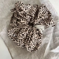 Elegant leopard print scrunchie hair tie with white pearl accents on grey fabric - Light Leopard Hair Tie with Pearls