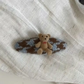Detail view of British style teddy bear plaid woven hair clip on linen background - Blue Coffee Rhombic Check Oval Bear Hair Clip