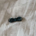 Detailed macro view of retro green marble acetate bow hair clip with sparkling rhinestones - Grey Blue Textured Style