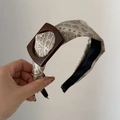 Detail view of paisley pattern fabric headband with decorative brown square buckle - Milk Tea Paisley Buckle Style