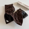 Elastico per capelli leopardato e finta pelle nera con logo metallico su fondo bianco - Leopardo Scuro Cachi