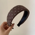 Detailed view of the thick padded vintage headband with white floral pattern on brown tweed - Coffee Wide Border White Flower Headband