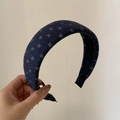 Close-up of dark blue knitted headband with white snowflake embroidery pattern - Blue Wide Border White Flower Headband