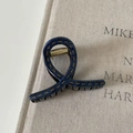 Detail of blue denim fabric hair claw clip with yellow stitching and gold metal spring - Denim Acrylic Small Cross Style