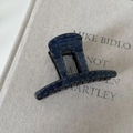 Detail of blue denim textured hair claw clip with contrast yellow stitching detail - Denim Acrylic Small Flat Claw Clip