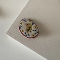 Detailed close-up of handmade embroidered chick on cotton linen floral hair clip fabric - Milk Tea Bird Round Style