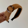 Detail of knitted wide-brim headband with tortoiseshell resin buckle in caramel brown - Ginger Yellow