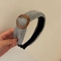 Detail view of light grey knitted wide headband with brown marble patterned ring buckle - Gray
