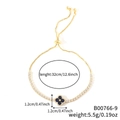 Bracciale dorato regolabile con ciondolo quadrifoglio blu e catena di zirconi - Trifoglio Oro con Centro Blu Scuro (B00766-9)