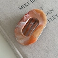 Detailed close-up of oval cut-out hair claw clip with amber marble texture finish - 1# Orange Oval Claw