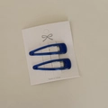 Detail of two dark blue drop-shaped BB hair clips on a white texture display card - Dark Blue