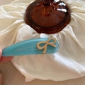 Detail of light blue acetate hair clip with beige bow on white wrinkled fabric - Blue Hair Clip Beige Bow (2#)