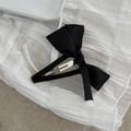 Macro view of a sweet black satin bow hair clip with silver metal BB clip attachment - Black