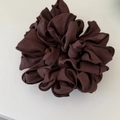 Close-up of fluffy dark brown chiffon hair scrunchie with detailed pleated edge stitching - Brown