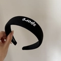 Black padded sponge headband with white sport embroidery for a high-volume hair look - Black