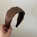 Close-up of a brown satin wide headband featuring a smooth silk texture and black lining - Glossy Brown