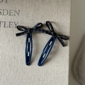 Detail of vintage navy blue plaid bow hair clips with oval hollow design and textured finish - Blue Grey Checkered Bow
