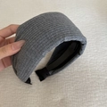 Close-up of grey ribbed knit headband featuring wide padded design and comfortable lining - Light Gray Striped Headband