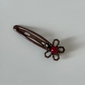 Close-up of brown dog hair clip featuring a resin flower with a red rhinestone center - Coffee Clip with Coffee Flower Red Dot