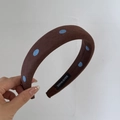 Close-up of brown headband with blue polka dots and a hand made woven label - 3cm Wide Headband