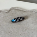 Detail of fabric oval hair clip featuring blue plaid pattern and dual heart accents - Gray Plaid Oval Heart