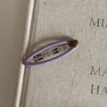 Close-up of a purple oval metal hair clip with a small brown heart on a beige background - 1# Purple Clip Coffee Heart