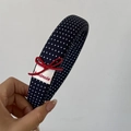 Detail of navy blue polka dot headband with a red handmade bow and woven label - Wide Headband / Blue White Polka Dot Wide Headband