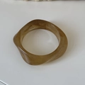 Macro shot of amber resin bracelet with irregular wavy texture and marble patterns - Light Milk Tea (12# Irregular Medium)