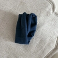 Detailed view of dark blue velvet fabric texture and soft knit scrunchie material - Blue