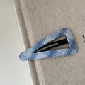 Blue and white plaid triangle hair clip with texture fabric on a beige book cover - Light Blue Plaid