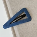 Macro shot of blue denim fabric texture on a triangular BB hair clip for women - Solid Denim Blue