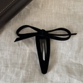 Pasador vintage de lazo de terciopelo negro para mujer sobre fondo minimalista de lino beige - Negro