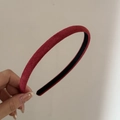 Detailed view of the soft velvet texture on a slim vintage burgundy corduroy headband - Red