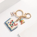 Detailed view of Back to School keychain with colorful book and apple charms - Letter Book