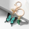Llavero de mariposa de acrílico verde azulado y negro con purpurina y borla verde - Mariposa Verde