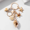 Ocean-themed acrylic keychain with shell and starfish charms on a white background - Textured Shell Starfish Style (款式五)