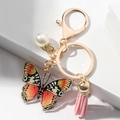 Detail of acrylic butterfly keychain with pink leather tassel and white faux pearl accent - Orange Butterfly