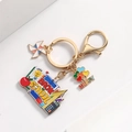 Golden school keychain with apple, blackboard and windmill charms for teacher gifts - Set Square Style