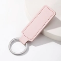 Minimalist light pink PU leather keychain with silver stainless steel ring on white pedestal - Rectangle / Pink