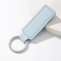 Minimalist light blue PU leather keychain with silver metal ring and stitch detail - Rectangle / Blue