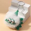 White fuzzy monster plush keychain with green silicone wings and soft decorative hat - White