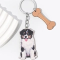 Detail view of 3D puppy keychain with a brown bone pendant on a minimal background - Australian Shepherd Style (Style Three)