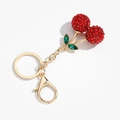 Close-up of sparkling red rhinestone cherry keychain with golden lobster clasp and green leaves - Green Leaf Red