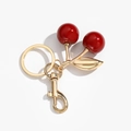 Fashionable cherry keychain with glossy red fruit and polished gold metal leaves - Red